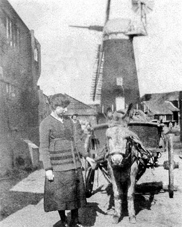 Olive Chapman and friend with the mill behind - 1911