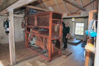 Mike Thurlow and the newly restored grain cleaner 